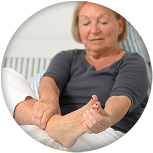 Woman checking right foot because of pain